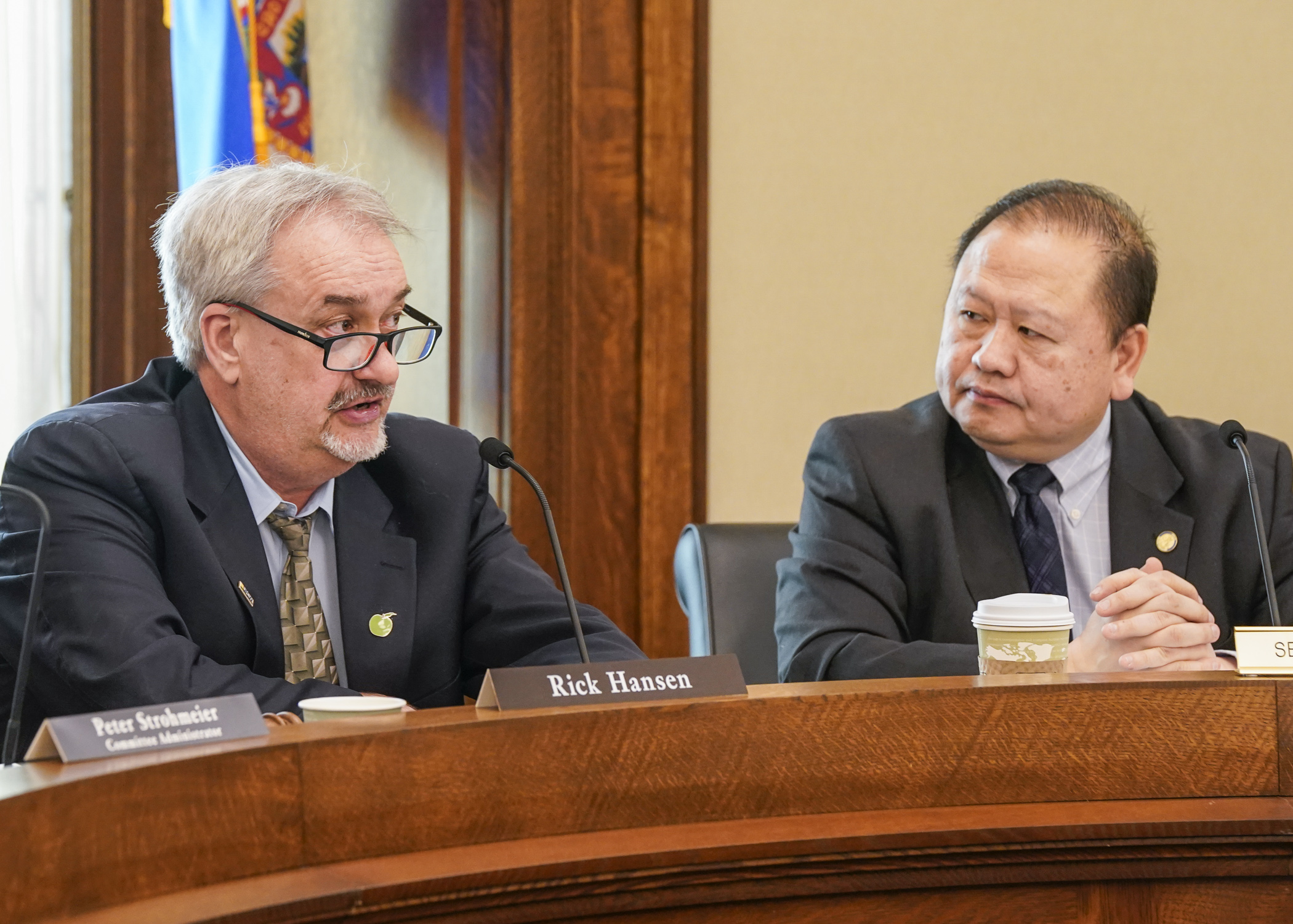 Sen. Foung Hawj, right, listens to Rep. Rick Hansen during a May 1 conference committee walkthrough of the House and Senate omnibus environment, natural resources, climate and energy bills. (Photo by Catherine Davis)