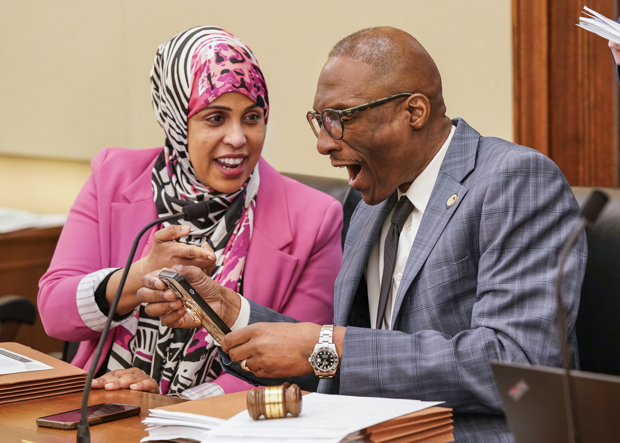 Rep. Hodan Hassan and Senate President Bobby Joe Champion enjoy a moment together May 1 before the first meeting of the omnibus jobs and labor conference committee. (Photo by Catherine Davis)