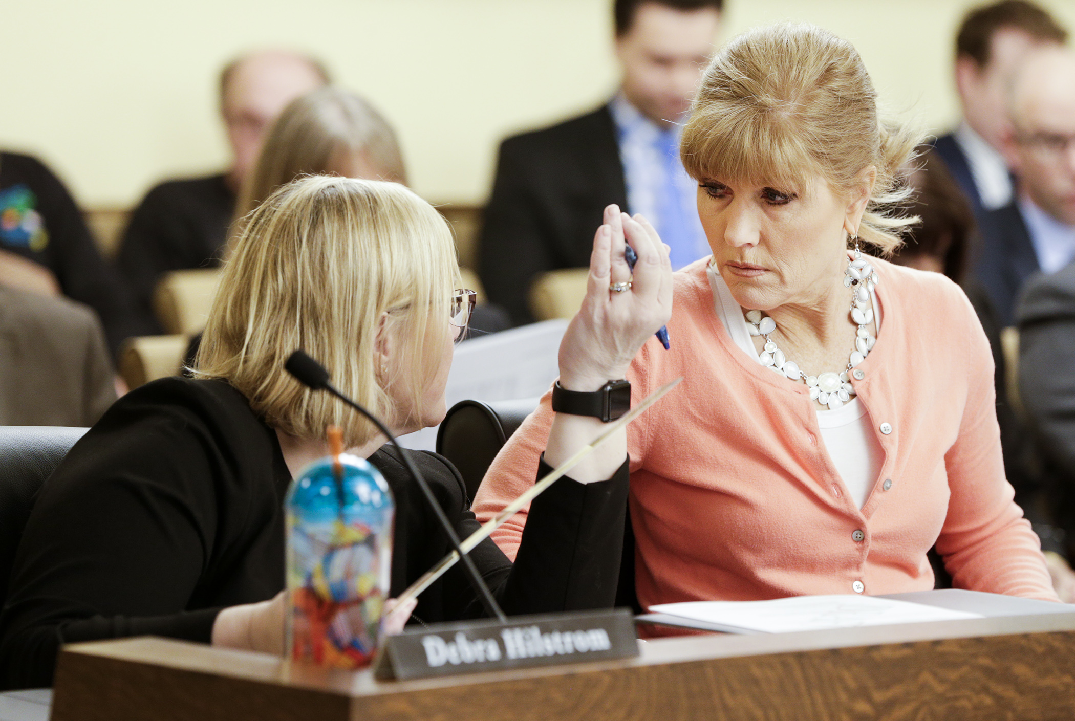 Rep. Debra Hilstrom, left, and Rep. Peggy Scott confer May 2 during the omnibus public safety conference committee. Photo by Paul Battaglia