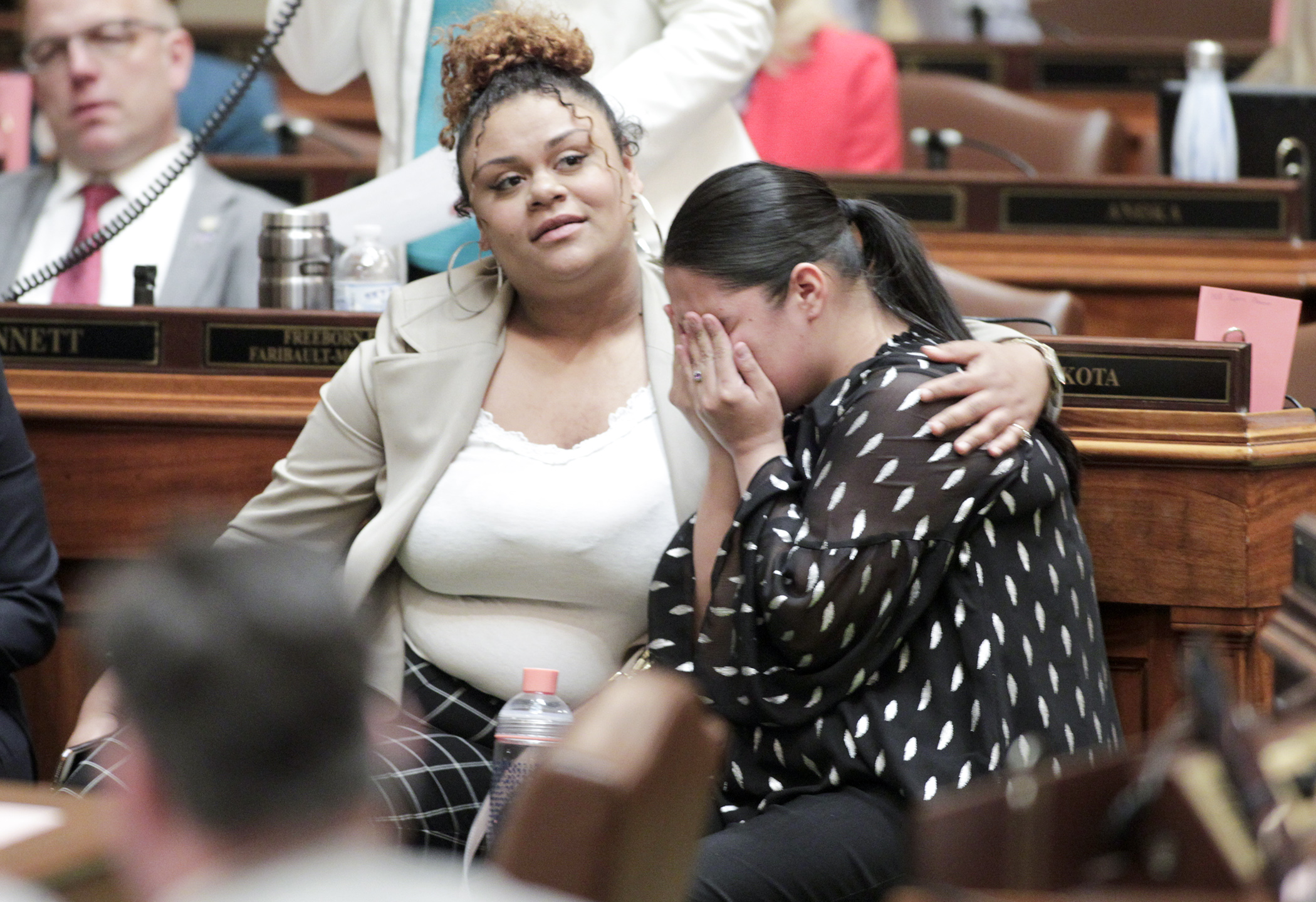 Sasha Martin gets a hug from Breanna Buckhalton as she is overcome with emotion after the House passed HF3265 which would, in part, establish a foster care sibling bill of rights. The two grew up in foster care and worked with legislators to bring about changes to the system. Photo by Paul Battaglia
