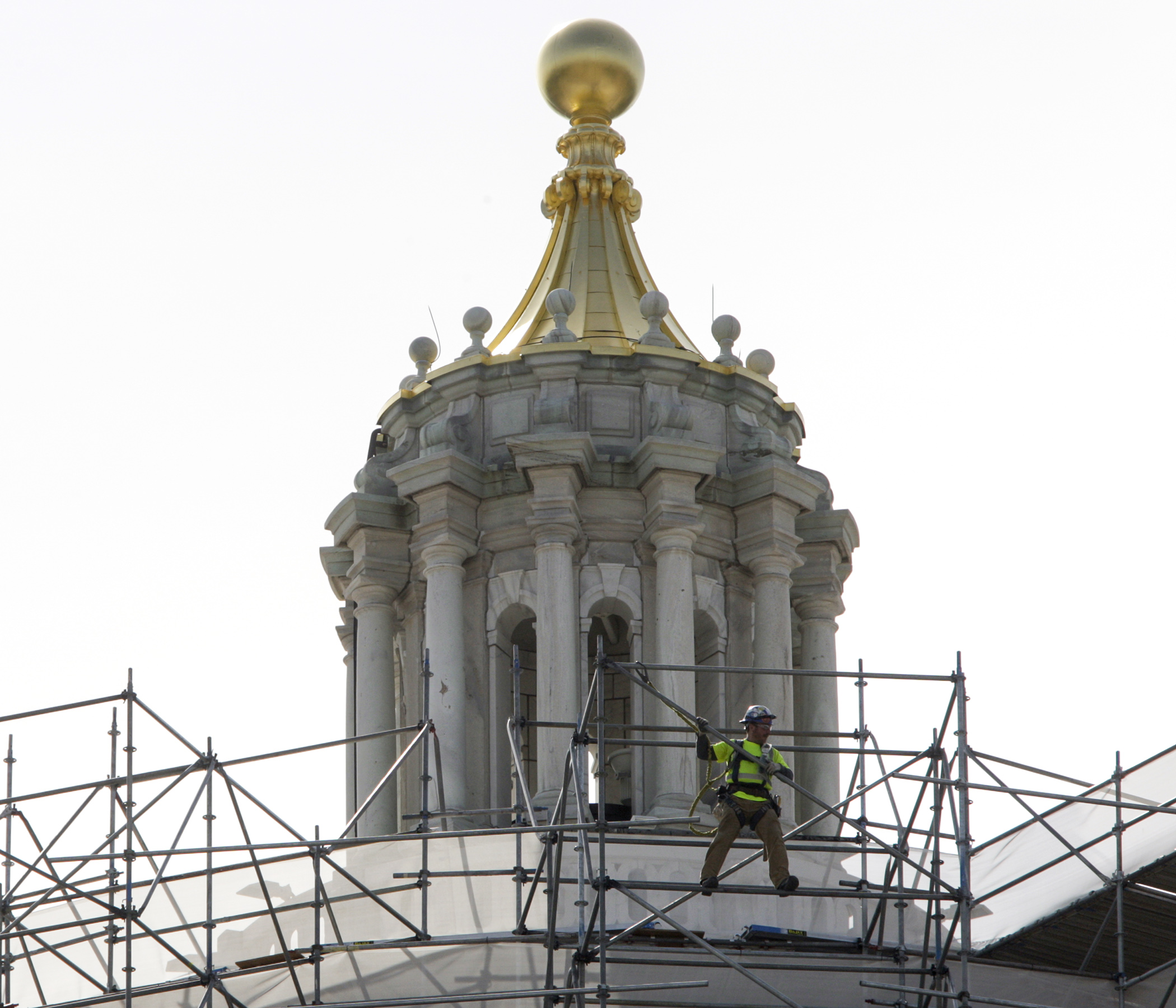 A worker slides along the upper most part of the scaffolding surrounding the Capitol dome May 3. Photo by Paul Battaglia