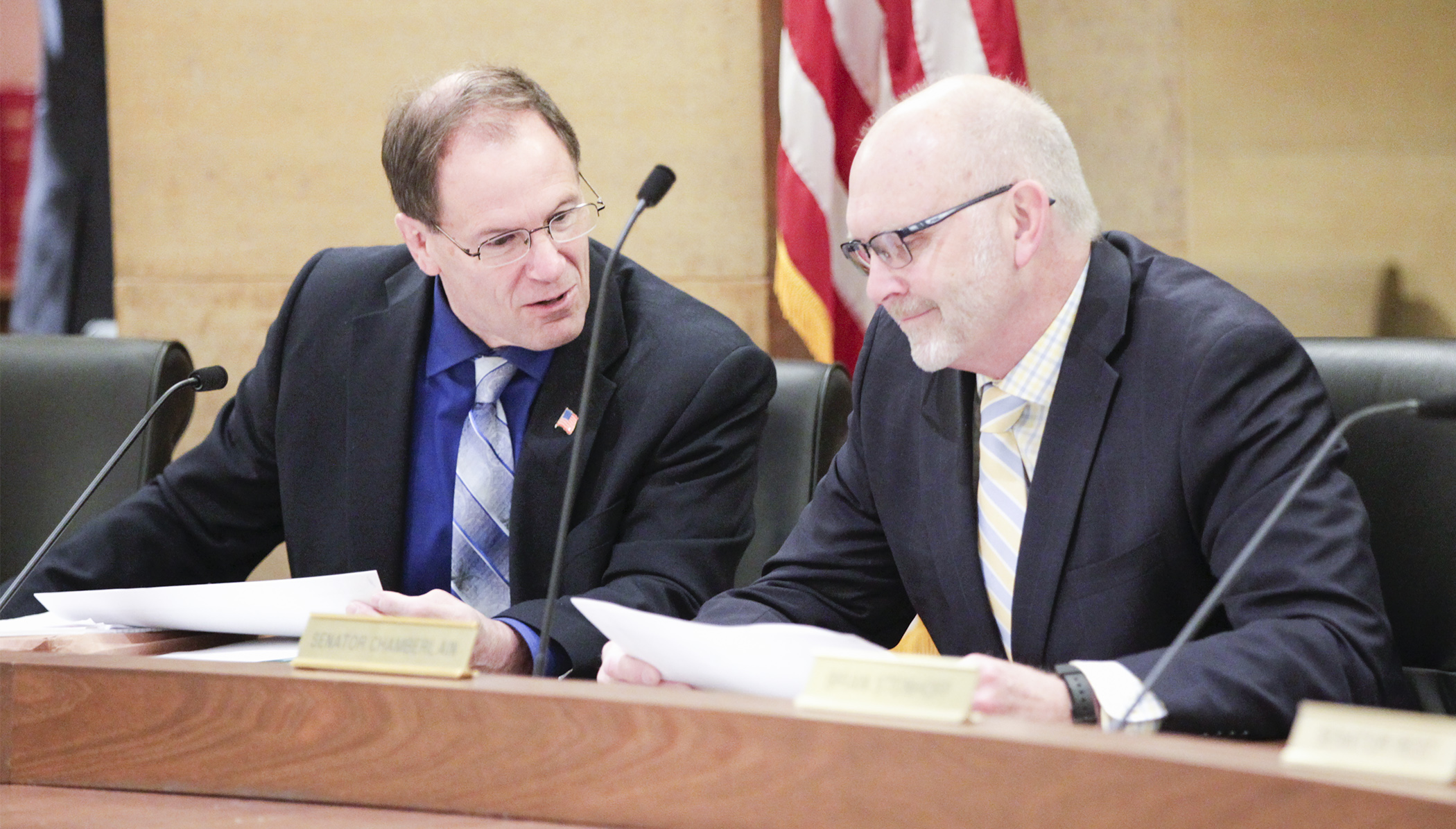 Rep. Paul Marquart, chair of the House Taxes Committee, confers with Sen. Roger Chamberlain, chair of the Senate Taxes Committee, before the first meeting of the conference committee on the omnibus tax bill May 3. Photo by Paul Battaglia