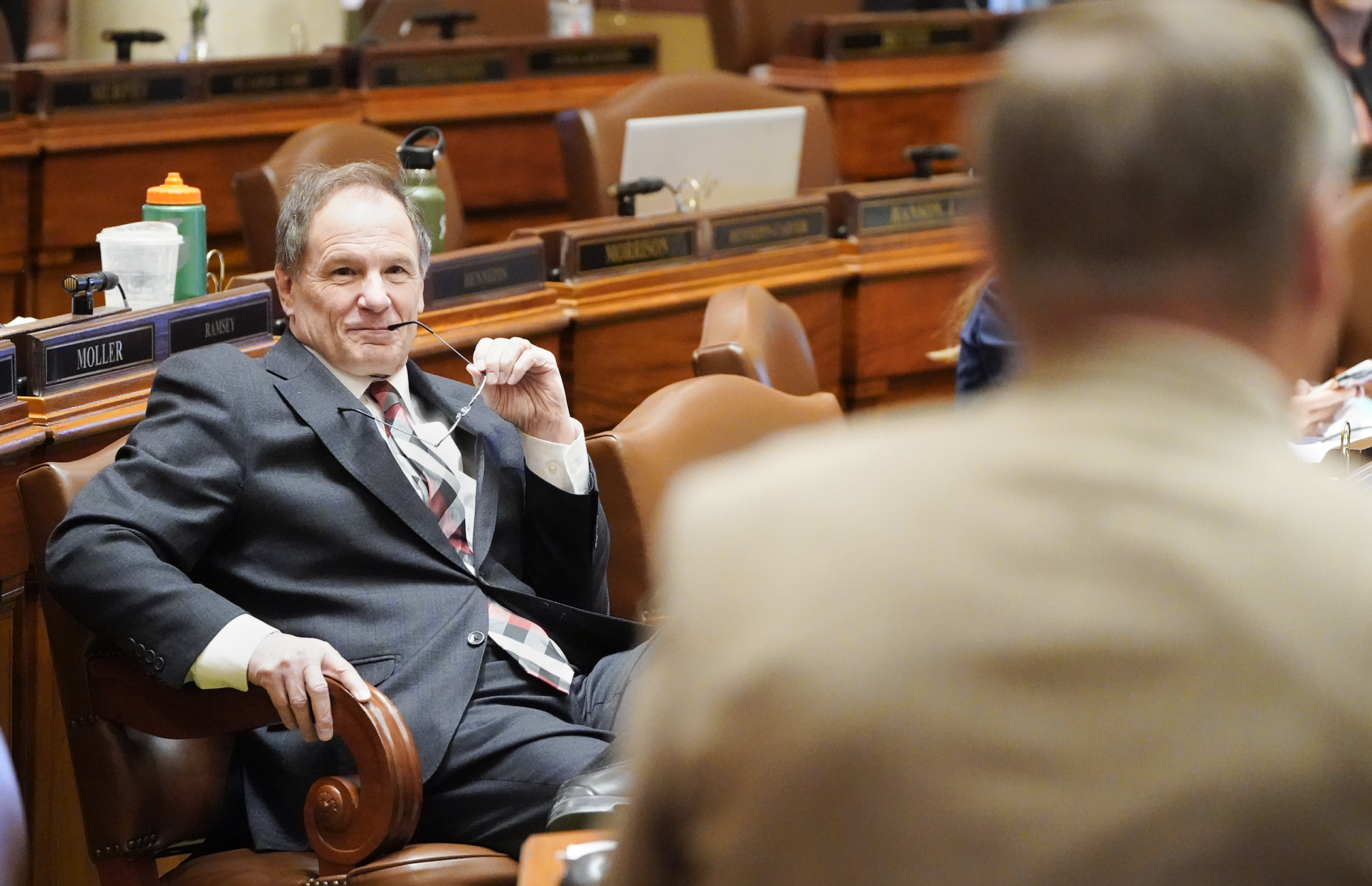 Rep. Paul Marquart, left, chair of the House Taxes Committee, listens as Rep. Glenn Gruenhagen comments during May 4 debate on the omnibus tax bill. (Photo by Paul Battaglia)