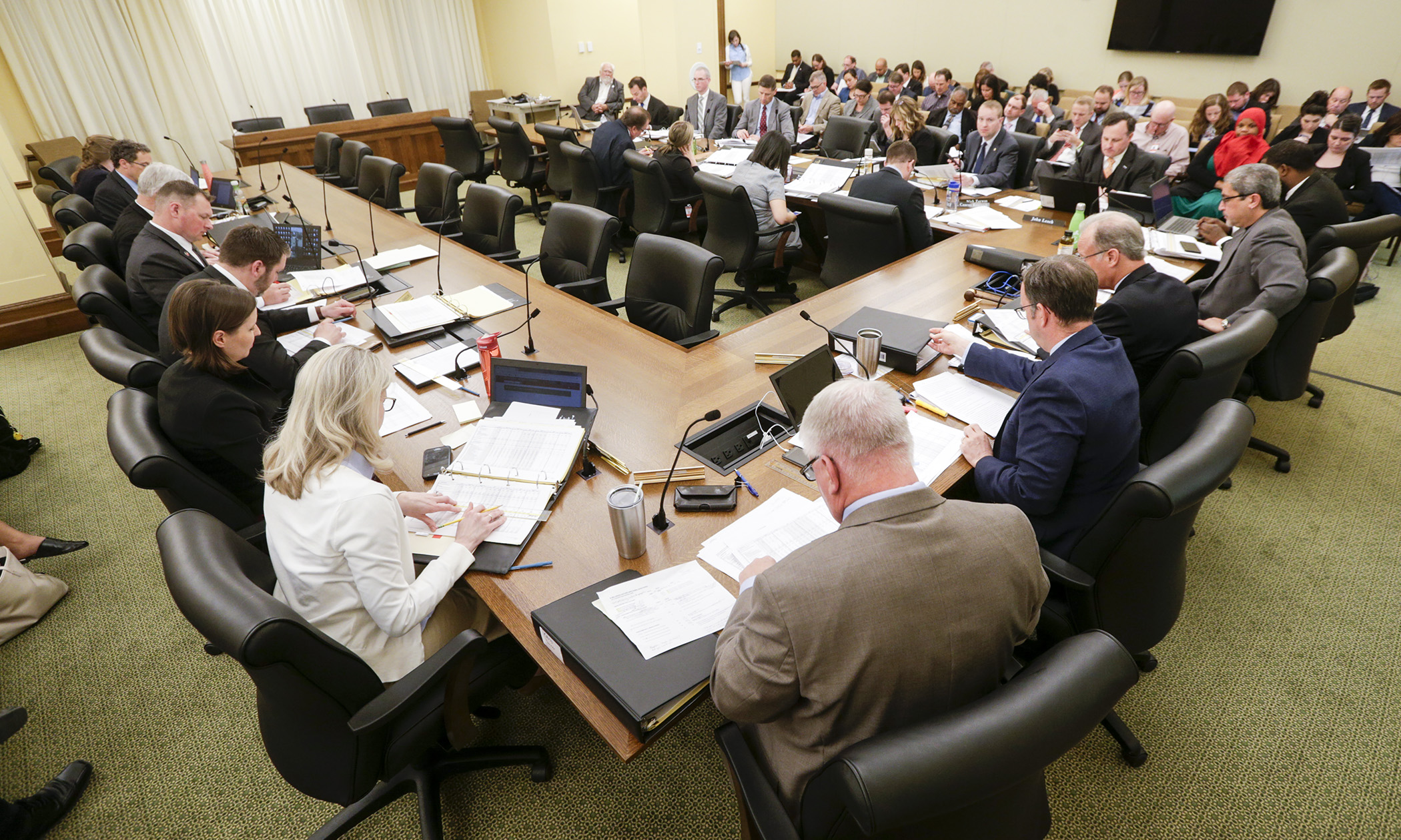 Conferees on the omnibus public safety finance bill listen as staff does a walk-through of the spreadsheet at their first meeting May 6. Photo by Paul Battaglia