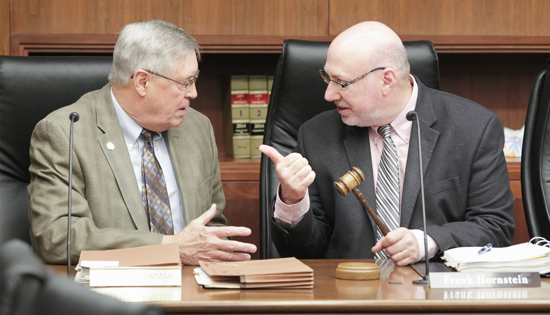 Sen. Scott Newman, left, and Rep. Frank Hornstein confer before the beginning of the May 6 meeting of the House-Senate conference committee on HF1555, the omnibus transportation finance bill. Photo by Paul Battaglia