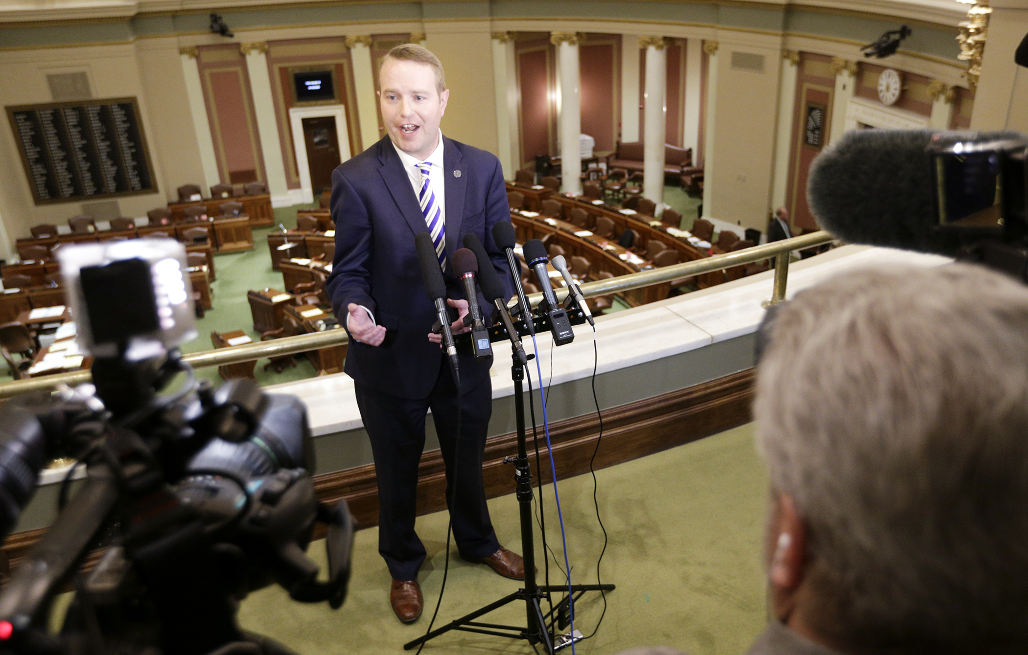 Before the May 8 House Floor debate, Rep. Nick Zerwas speaks with the media about HF390, which would, in part, increase the penalty for obstructing a freeway or access to an airport. Photo by Paul Battaglia