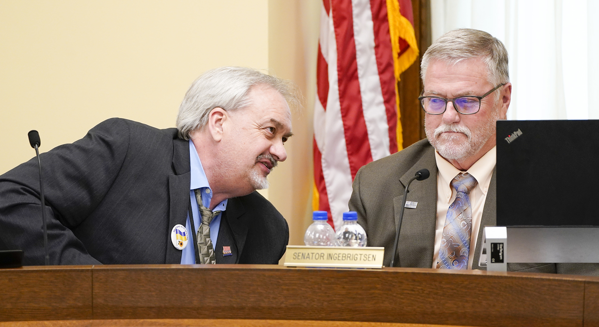 Rep. Rick Hansen, left, and Sen. Bill Ingebrigtsen confer May 9 during the first meeting of the conference committee on HF4492/SF4062*, the omnibus environment, natural resources, and tourism bill. (Photo by Paul Battaglia)