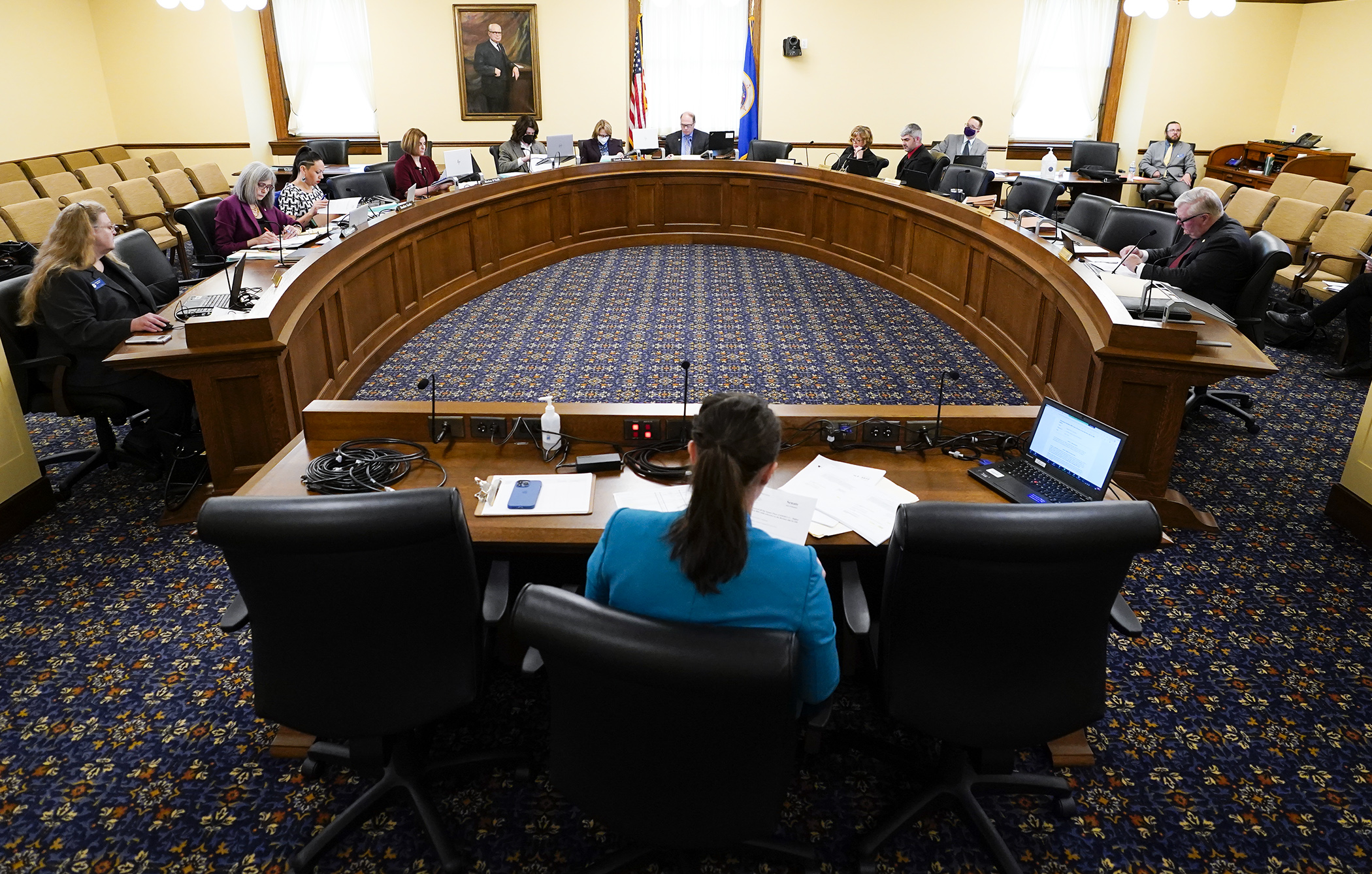 Members of the conference committee listen as staff does a side-by-side comparison of the House and Senate higher education omnibus bills during their first meeting May 11. (Photo by Paul Battaglia)