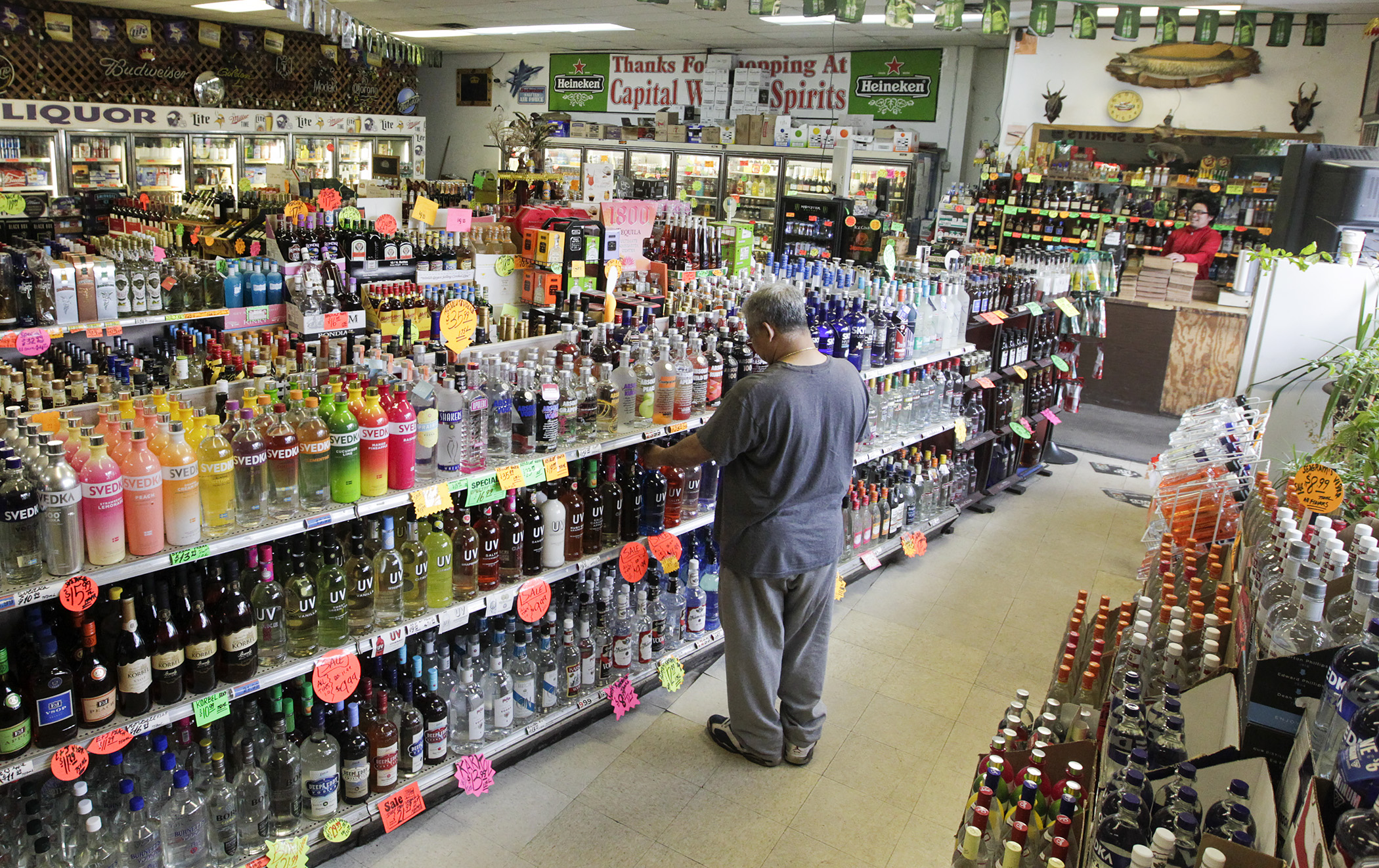 A shopper peruses the bottles on offer Thursday at Capital Wine and Spirit on Rice Street in St. Paul. Photo by Paul Battaglia