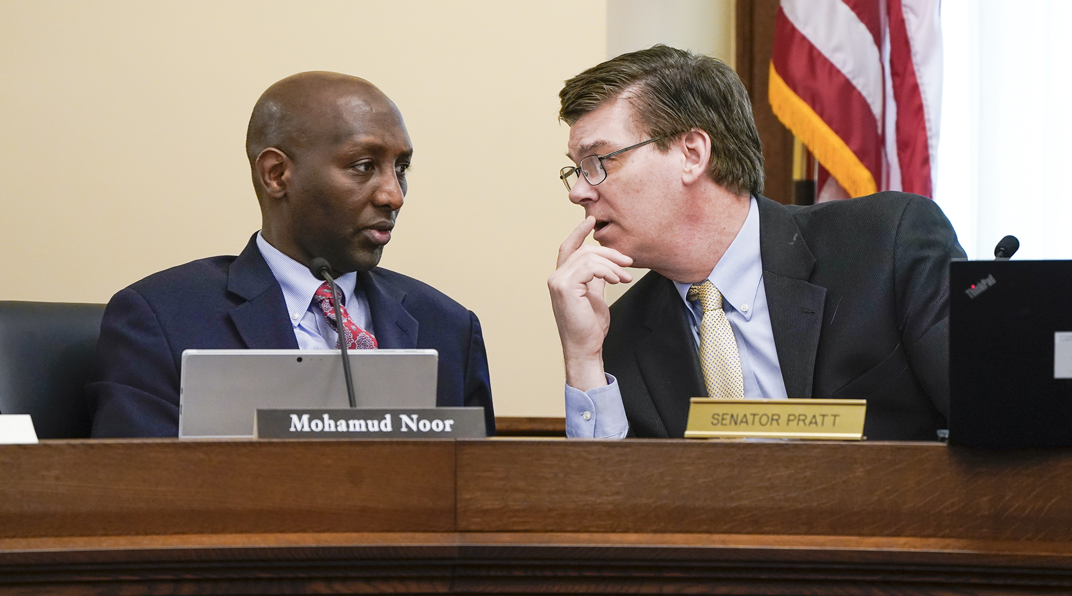 Rep. Mohamud Noor and Sen. Eric Pratt confer during the first meeting of the conference committee on SF4091 — the omnibus jobs, energy and commerce bill — May 12. (Photo by Paul Battaglia)