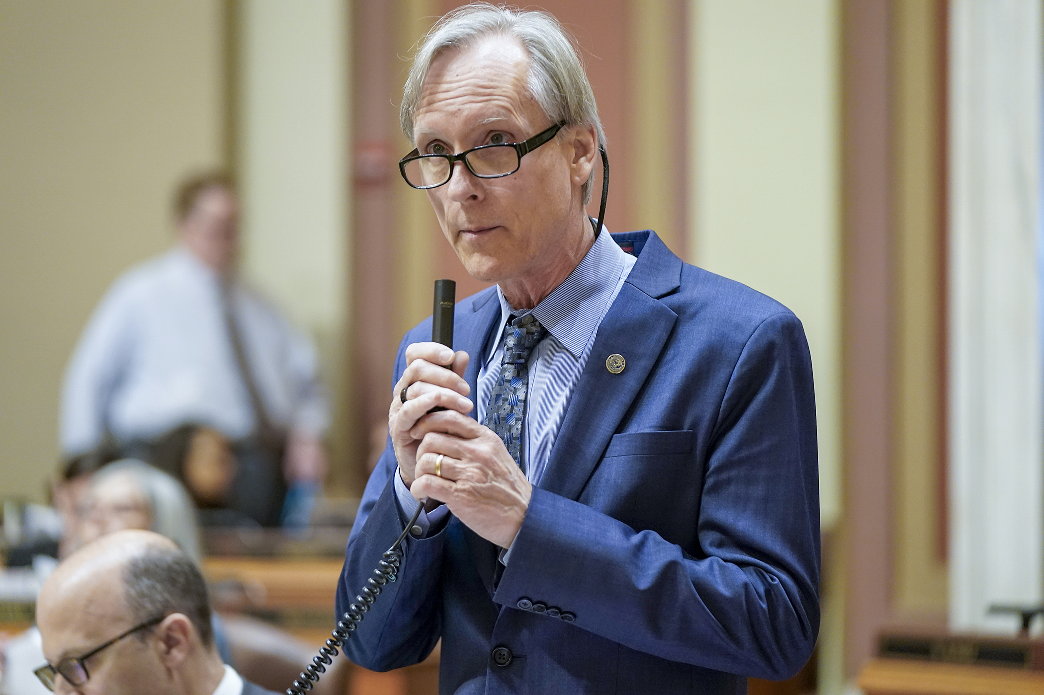 Rep. Robert Bierman, co-chair of the House Health Finance and Policy Committee, introduces an amendment to the omnibus health and children and families finance bill May 12 on the House Floor. (Photo by Michele Jokinen)