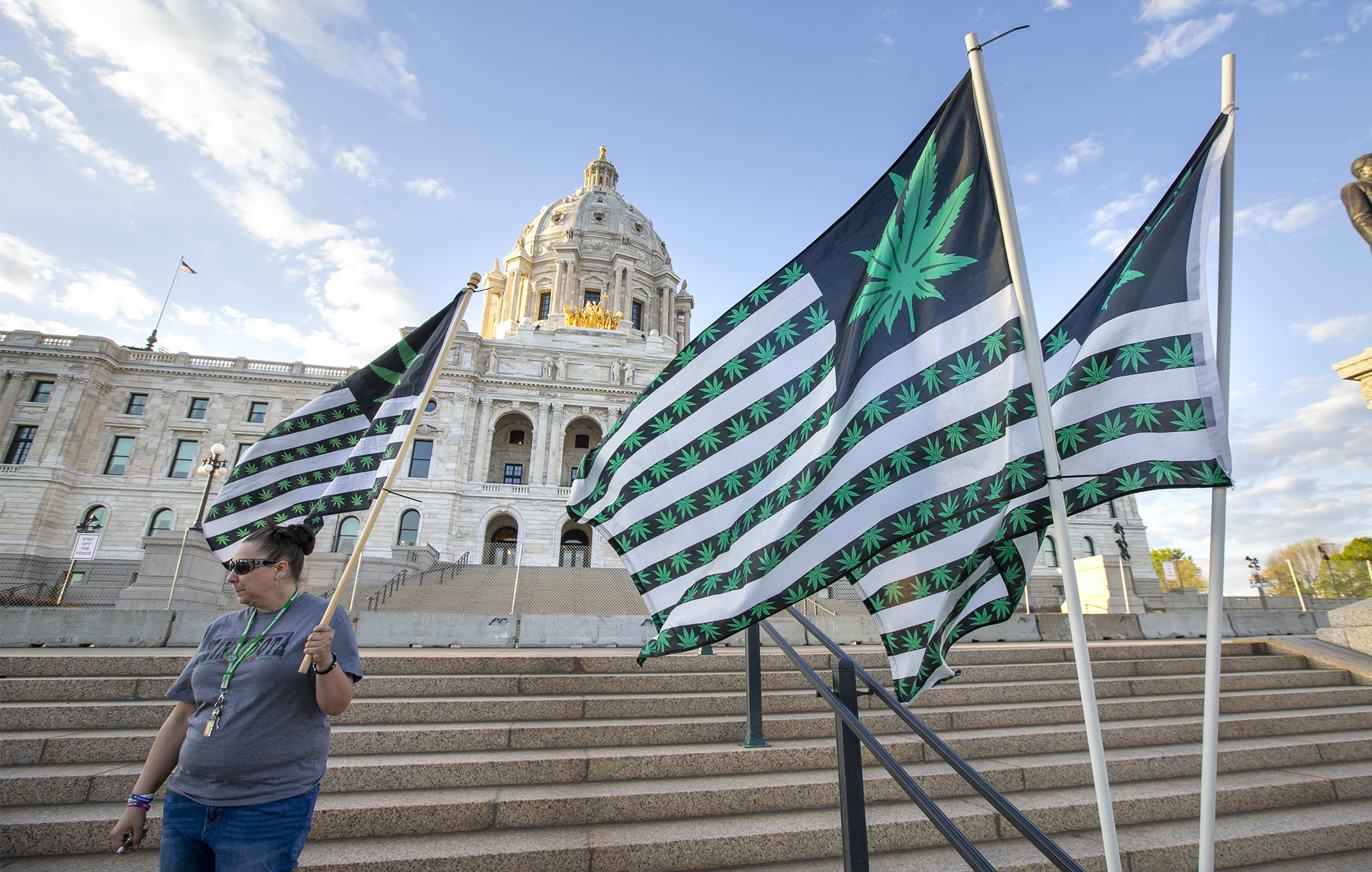 A supporter of marijuana legalization stands on the Capitol steps in 2021. (House Photography file photo)