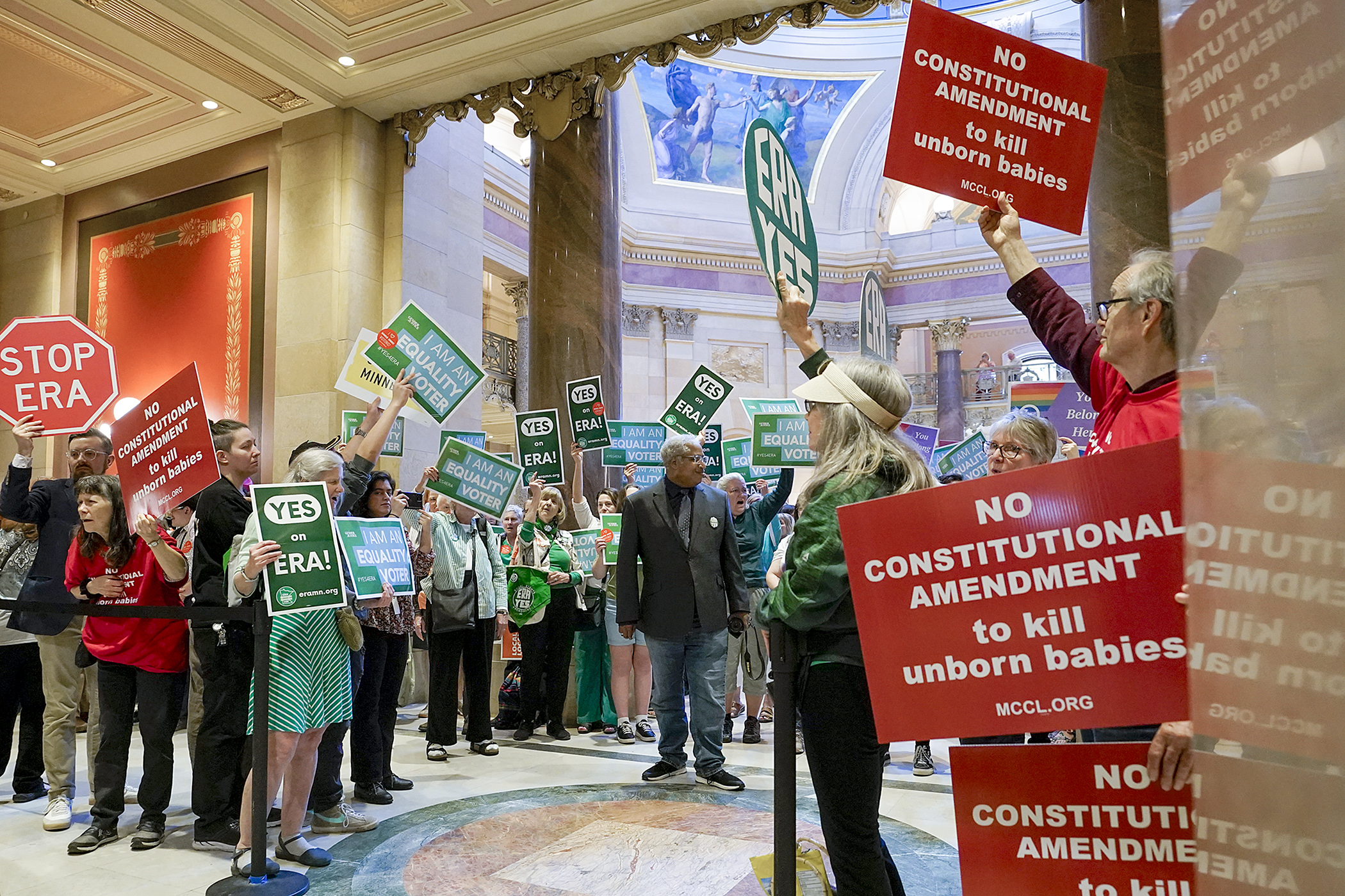 Proponents and opponents of a proposed equal rights constitutional amendment rally Monday outside the House Chamber. An expected vote Monday on the measure did not occur. (Photo by Michele Jokinen)
