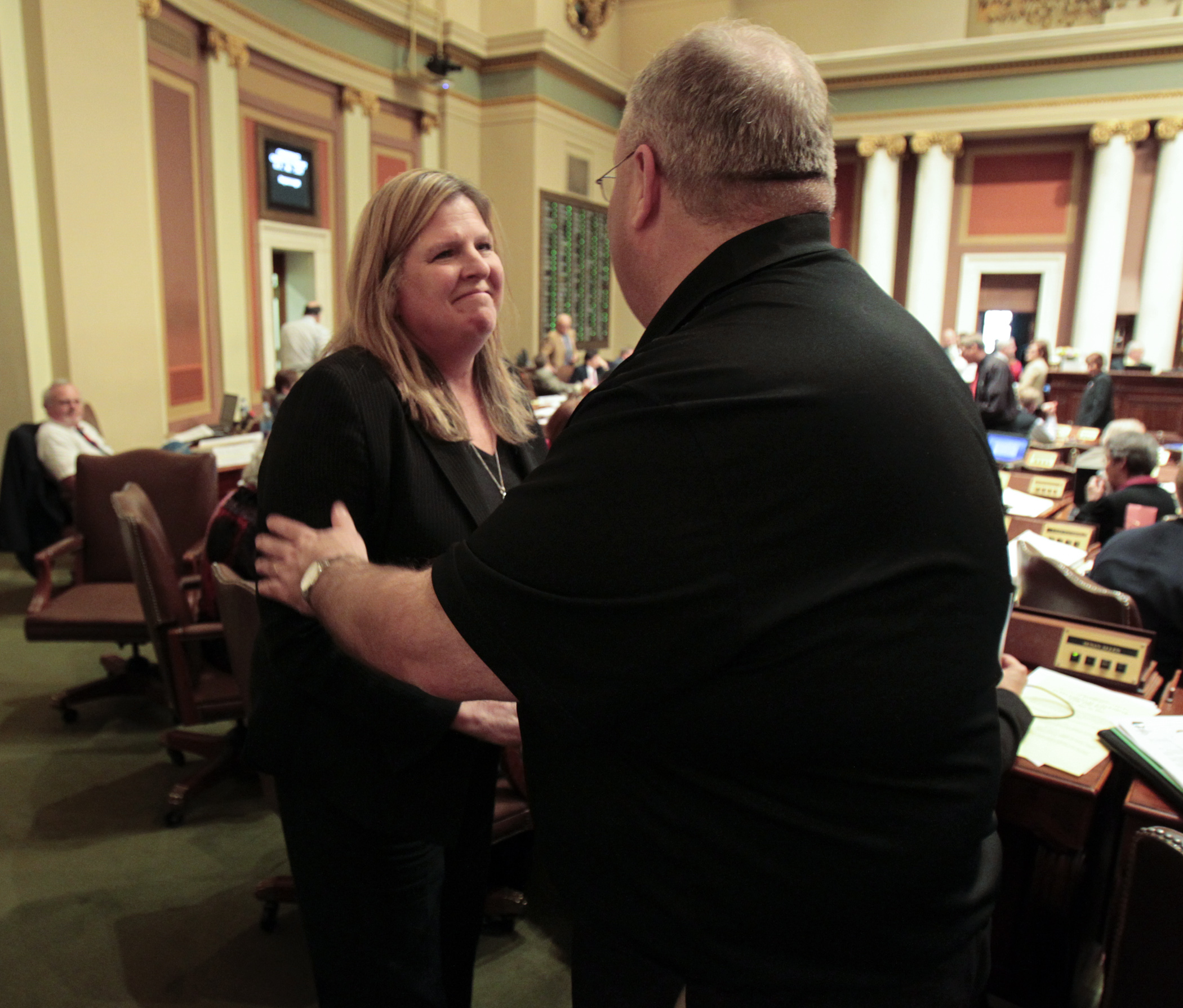 House Taxes Committee Chair Rep. Ann Lenczewski is congratulated by Rep. Greg Davids, the committee Republican lead, after the House passed the omnibus supplemental tax bill May 16. Photo by Paul Battaglia