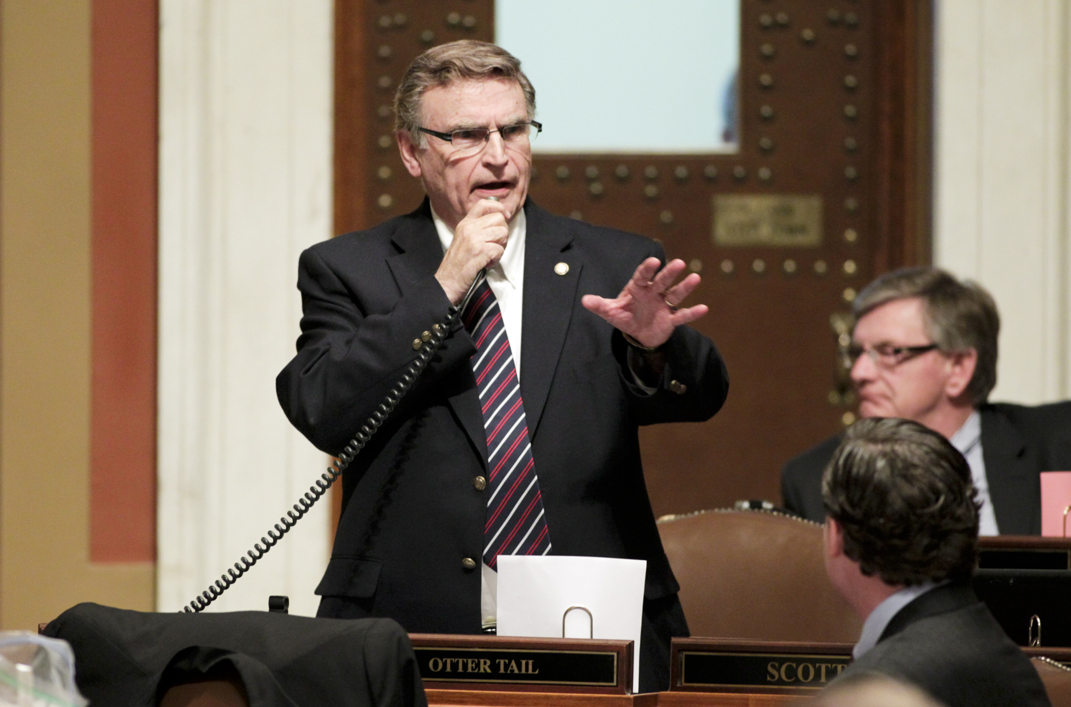 Rep. Bud Nornes, chair of the House Higher Education Policy and Finance Committee, explains provisions of the conference committee report on HF845/SF5* during floor debate May 17. Photo by Paul Battaglia