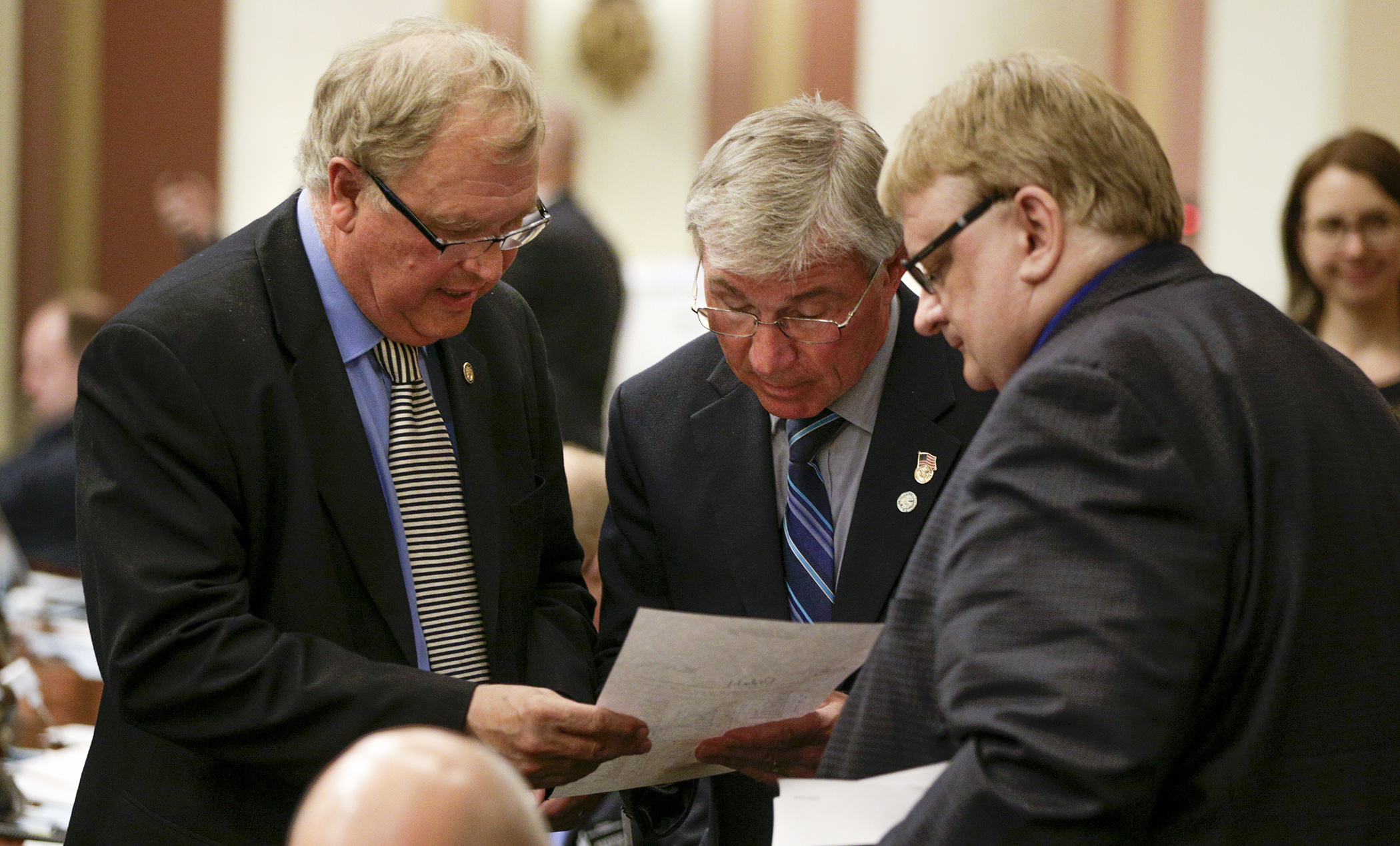 Rep. Dean Urdahl, from left, Rep. Bob Dettmer and Rep. Duane Quam check the vote register after the omnibus capital investment bill failed to get the three-fifths majority needed to pass May 17. Photo by Paul Battaglia