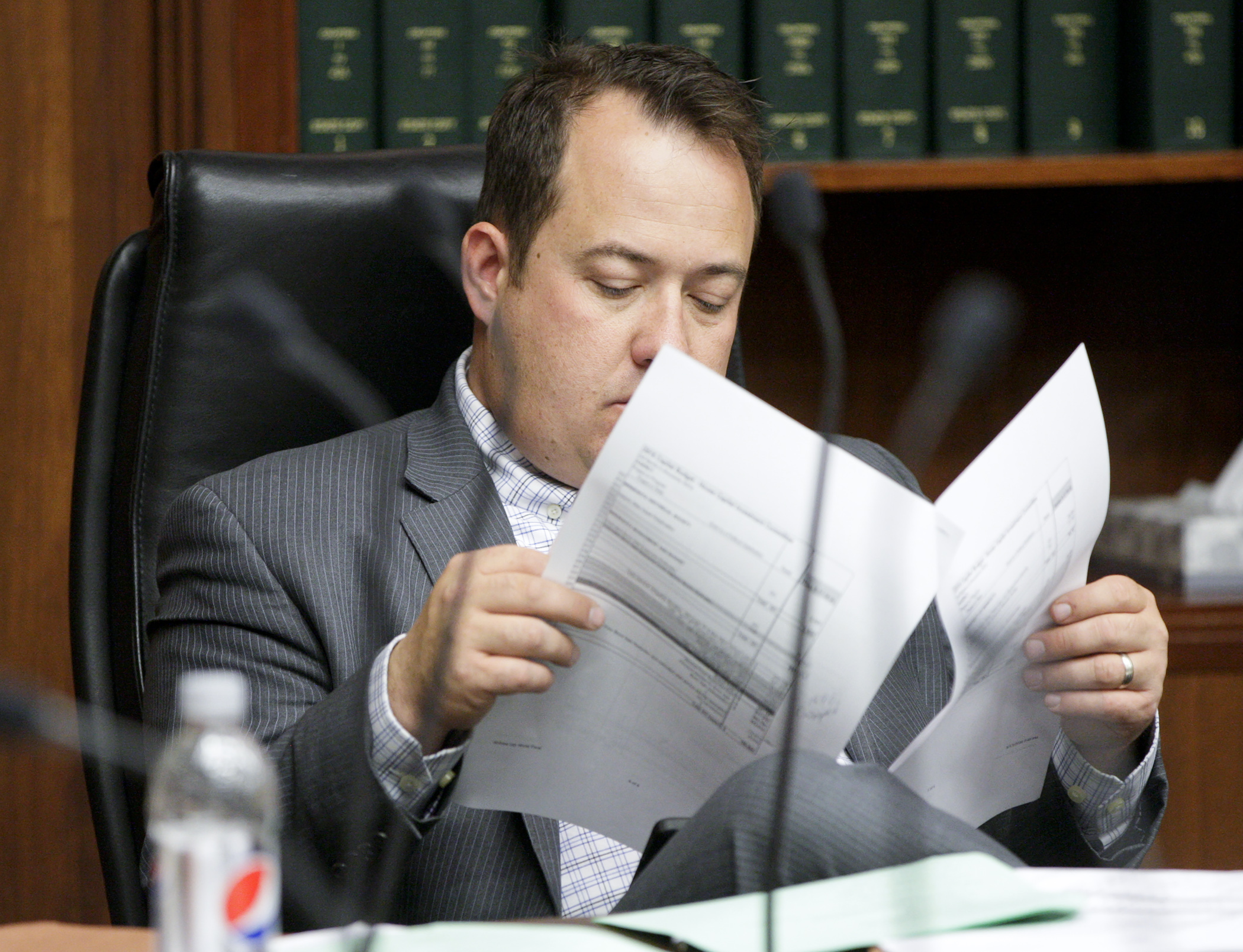 Rep. Chris Swedzinski looks over a document during the House Capital Investment Committee’s discussion of the $800 million capital investment bill May 18. Photo by Paul Battaglia