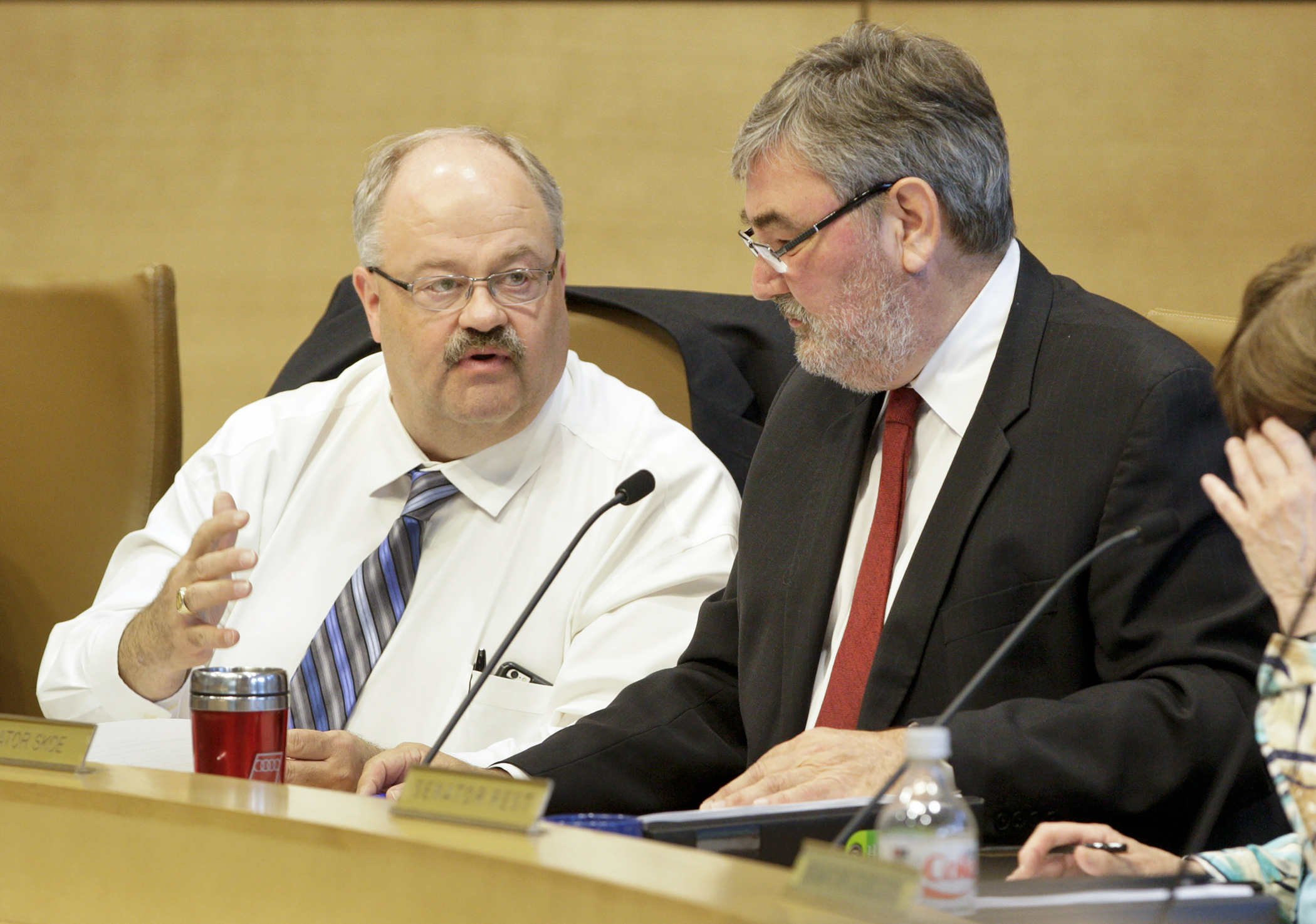 Rep. Greg Davids, left, and Sen. Rod Skoe confer during discussion of an amendment at the May 18 meeting of the tax conference committee. Photo by Paul Battaglia