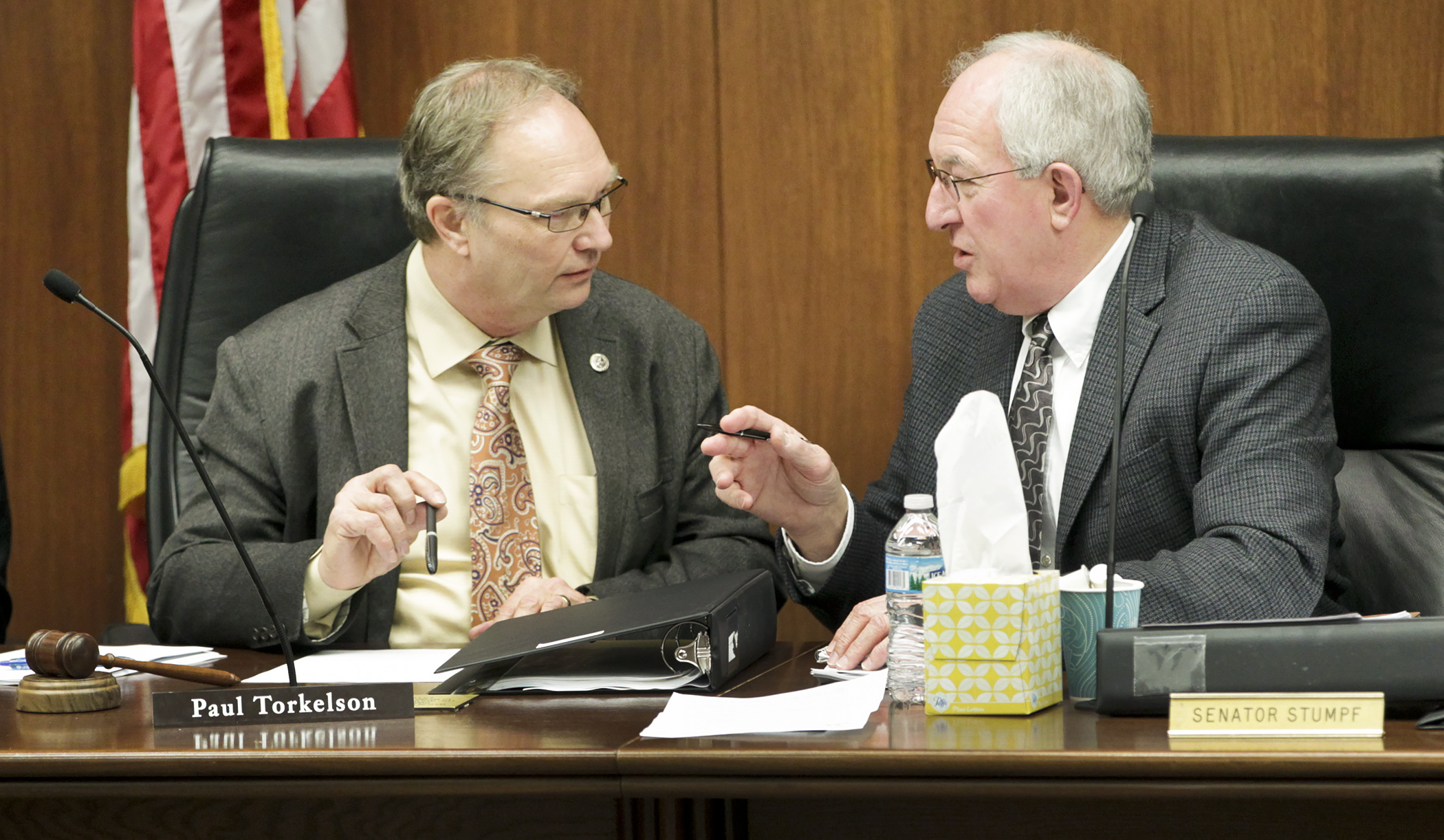 Rep. Paul Torkelson, left, and Sen. LeRoy Stumpf confer before the first meeting of the capital investment conference committee May 20. Photo by Paul Battaglia