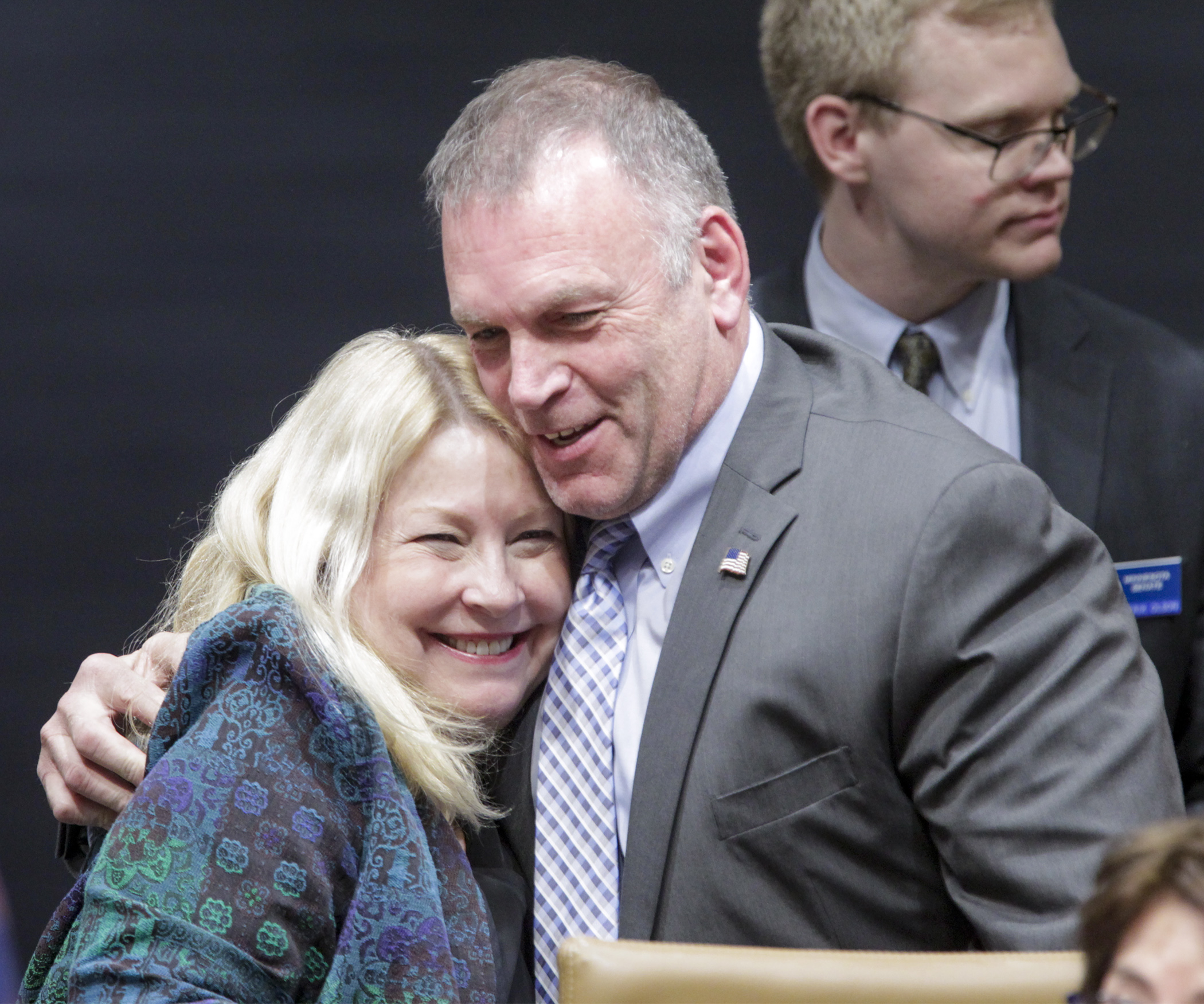 Rep. Dave Baker and Sen. Chris Eaton, who both lost children to opioid addiction, share a hug after the opioids conference committee wrapped up its work May 20. Photo by Paul Battaglia.