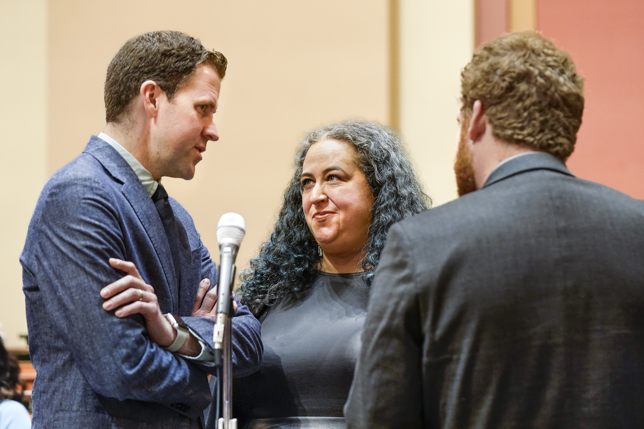 Rep. Aisha Gomez and House Majority Leader Jamie Long talk during a break in the May 20 debate on HF1938, the tax finance and policy bill. (Photo by Catherine Davis)