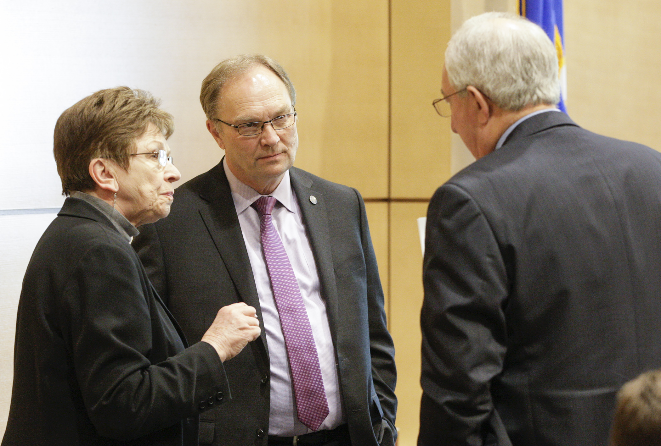 Rep. Paul Torkelson, center, and Rep. Alice Hausman confer with Sen. LeRoy Stumpf before a May 21 afternoon meeting of the capital investment conference committee. House Photography file photo