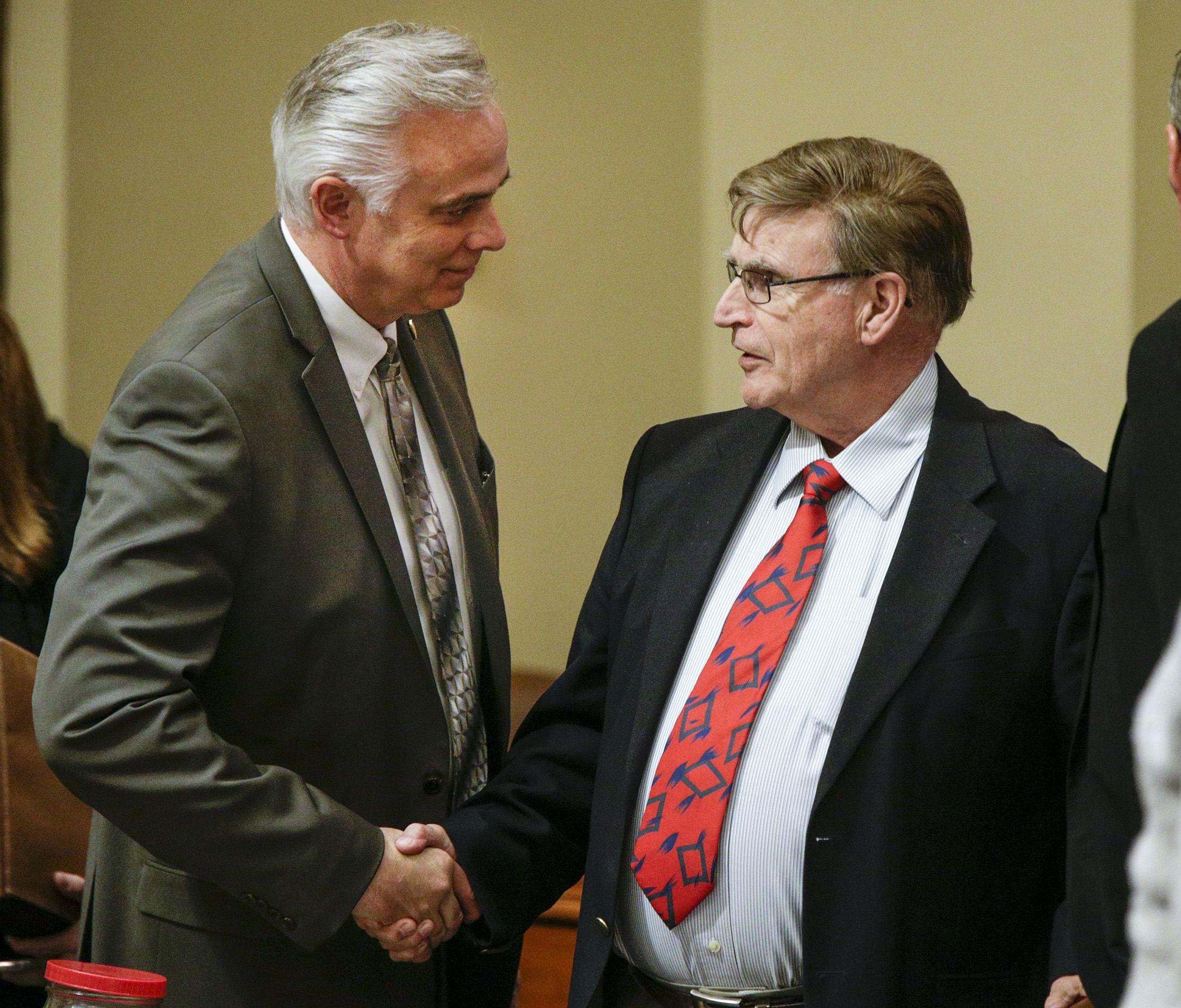 Rep. Tony Albright, left, congratulates Rep. Bud Nornes after passage of the omnibus higher education conference committee report. Photo by Paul Battaglia