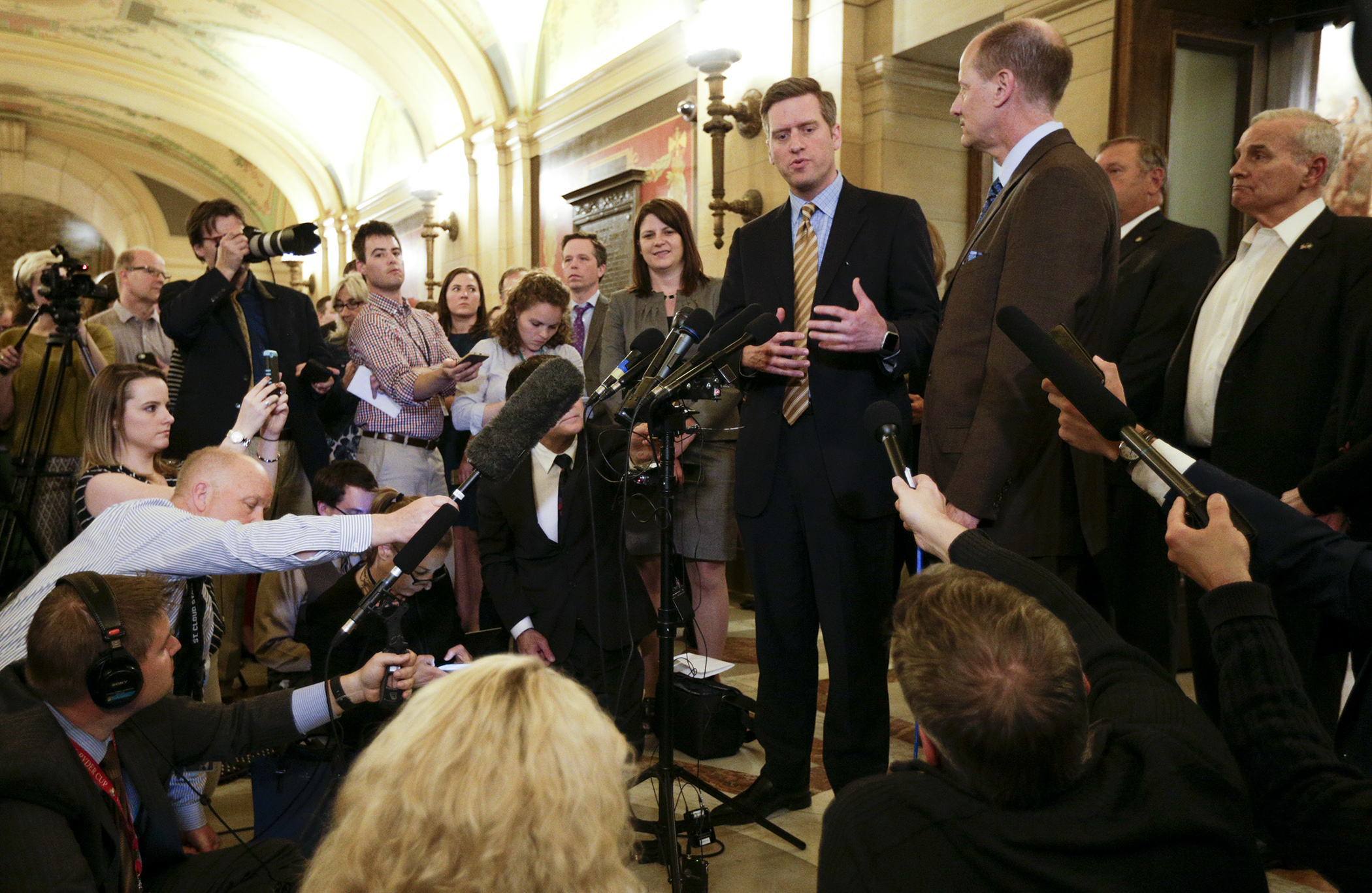 Surrounded by other legislative leaders and Gov. Mark Dayton late Monday night, House Speaker Kurt Daudt announces a tentative budget agreement has been reached and a special session will begin at 12:01 a.m. May 23. Photo by Paul Battaglia