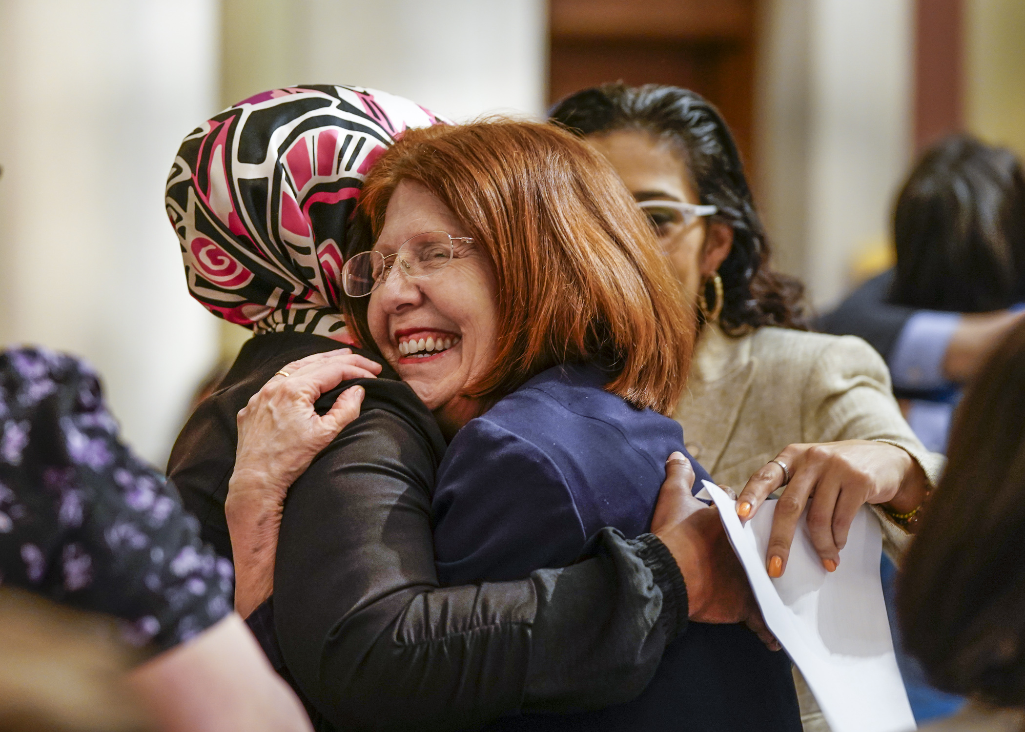 Rep. Tina Liebling hugs Rep. Hodan Hassan after the passage of SF2995, the health and human services finance bill, May 22. (Photo by Catherine Davis)