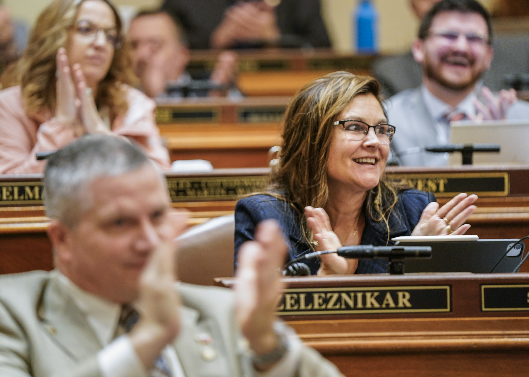Rep. Natalie Zeleznikar and other House members applaud following the passage of HF3342, a bill to support nursing home facilities. (Photo by Catherine Davis)