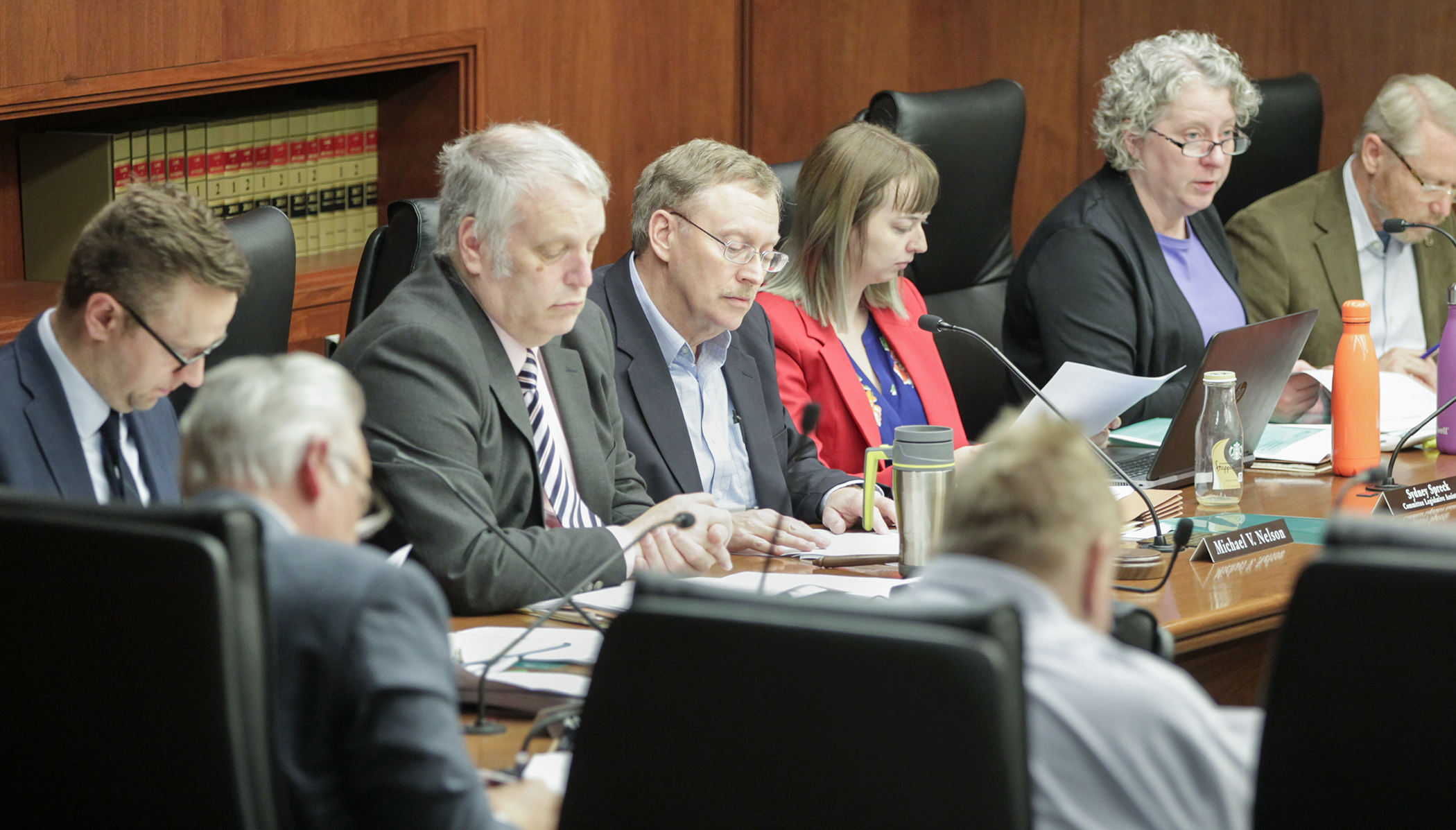 Members of the House State Government Finance Division listen May 23 to a walk-through of the omnibus state government, military affairs, and veterans affairs finance agreement to be introduced when a special session is called. Photo by Paul Battaglia