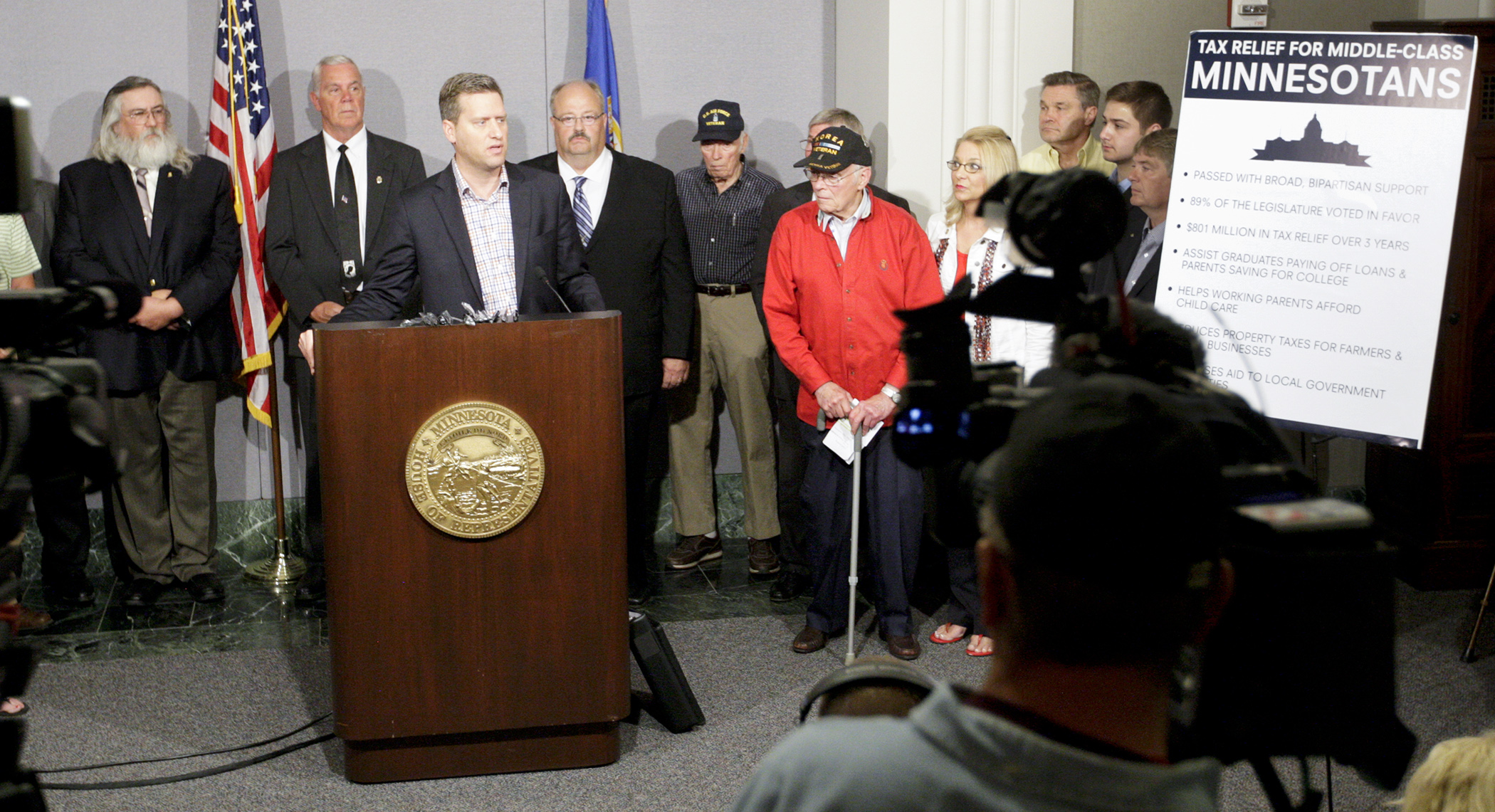 Flanked by House Republicans and citizens that include veterans, farmers and college students, House Speaker Kurt Daudt urges Gov. Mark Dayton to sign the omnibus tax bill. Photo by Paul Battaglia