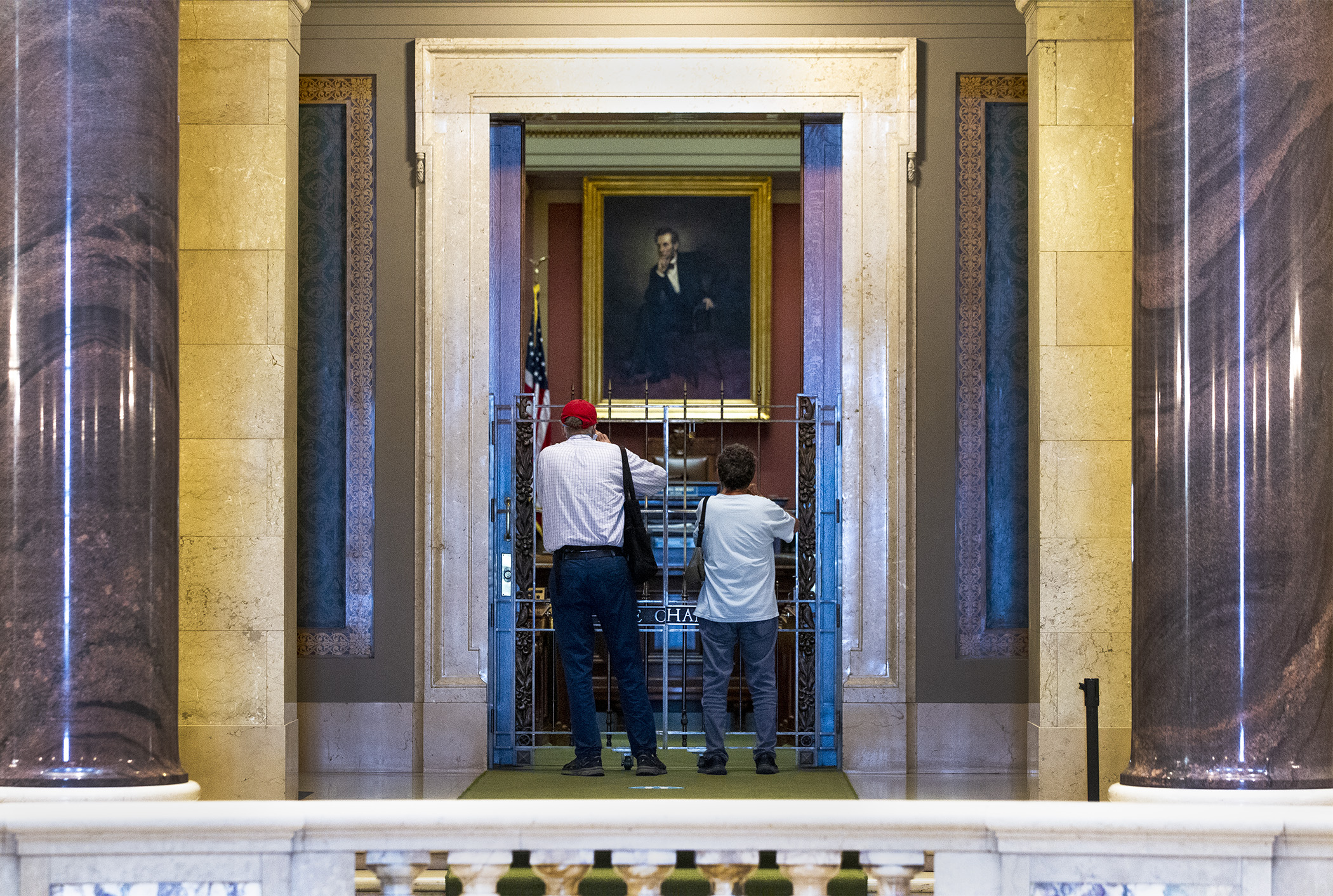 Alan Gabbay, left, of Chicago, and Jack Melroy of San Diego, peer into the House Chamber June 11, three days before a special session is to begin. Photo by Paul Battaglia