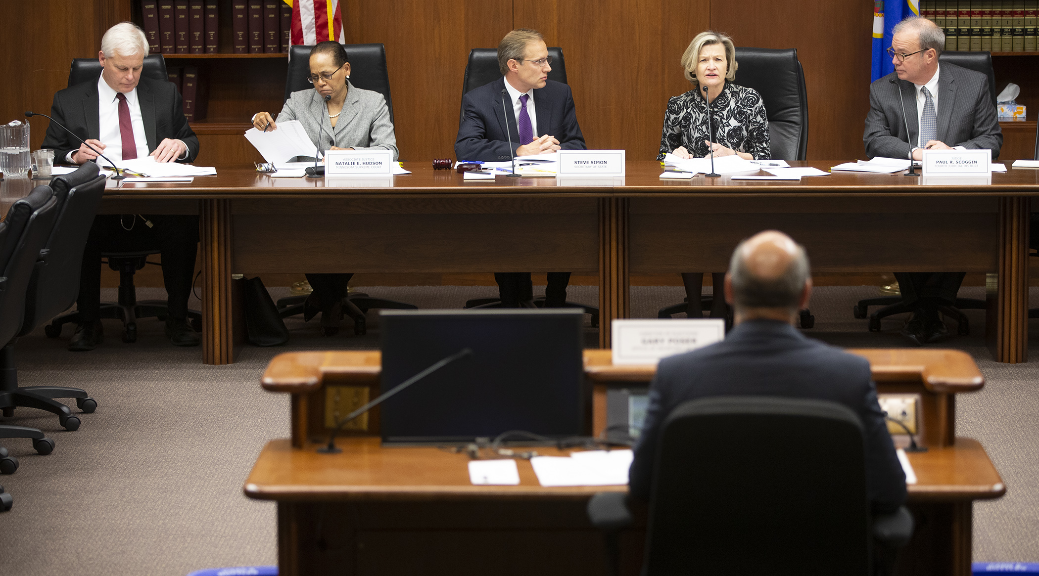 Fourth Judicial District Chief Judge Ivy S. Bernhardson asks a question of State Elections Director Gary Poser Tuesday as he presents the canvassing report for the Nov. 6 general election to the State Canvassing Board. Photo by Paul Battaglia