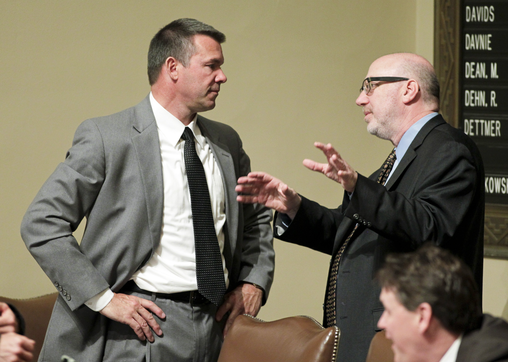 House transportation chair Rep. Tim Kelly (left) and Rep. Frank Hornstein converse last April on the House floor before debate on the omnibus transportation finance bill. House Photography file photo